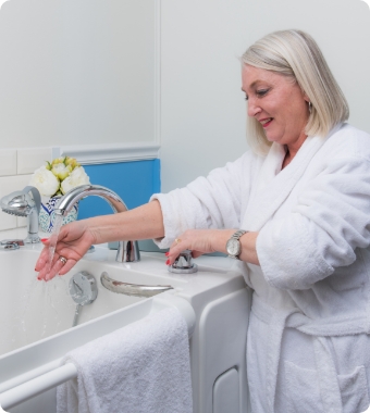 woman testing bath water temp