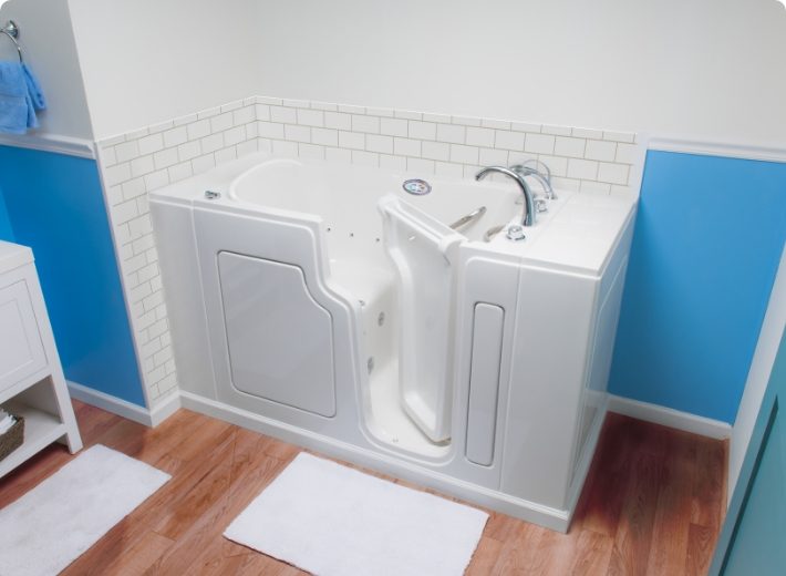 walk-in tub with white tile backsplash
