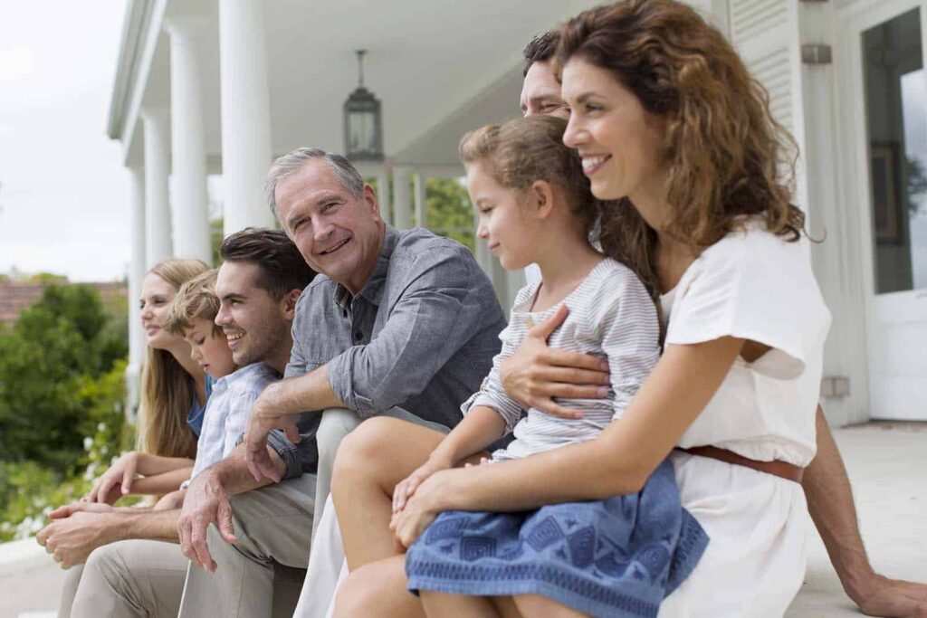 family sitting on their front porch