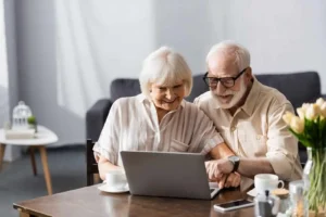 elderly couple browsing together online