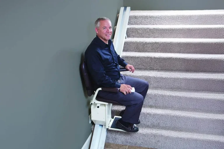 man ascending stairs on indoor Safe Step stairlift