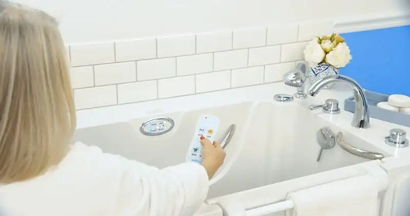Woman Controlling Bathtub with Remote