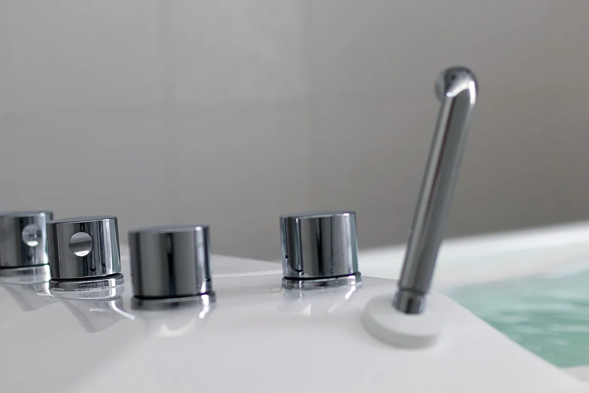 Various knobs and faucet on bathtub